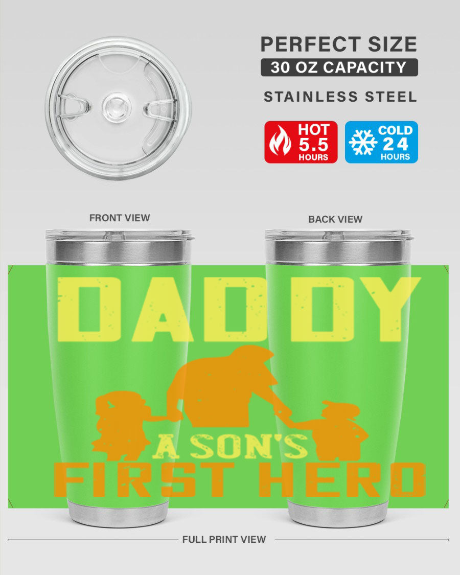 A stylish stainless steel tumbler with the phrase 'Daddy a Son's First Hero' printed on it, available in 20oz and 30oz sizes.