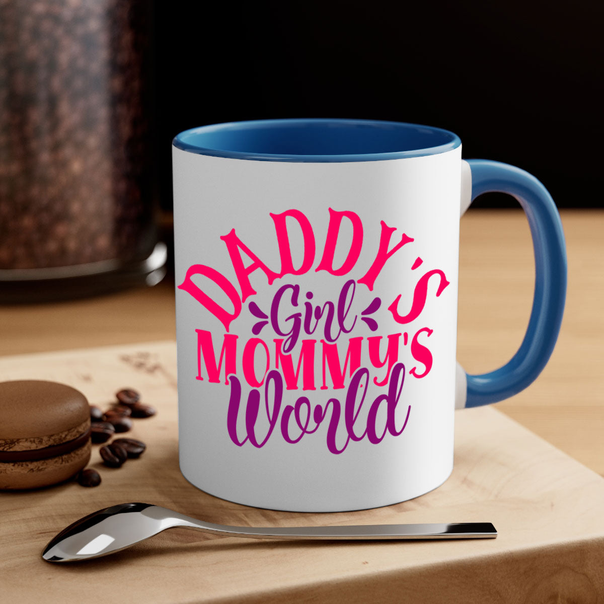 A two-tone ceramic coffee mug with a colored handle and interior, featuring the phrase 'Daddy's Girl Mommy's World' in a glossy finish.