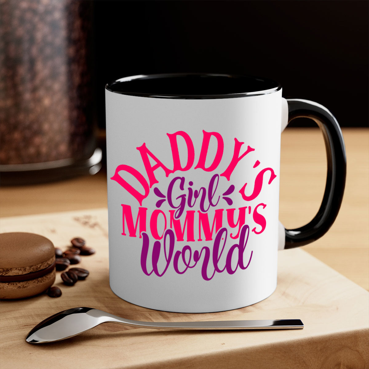A two-tone ceramic coffee mug with a colored handle and interior, featuring the phrase 'Daddy's Girl Mommy's World' in a glossy finish.