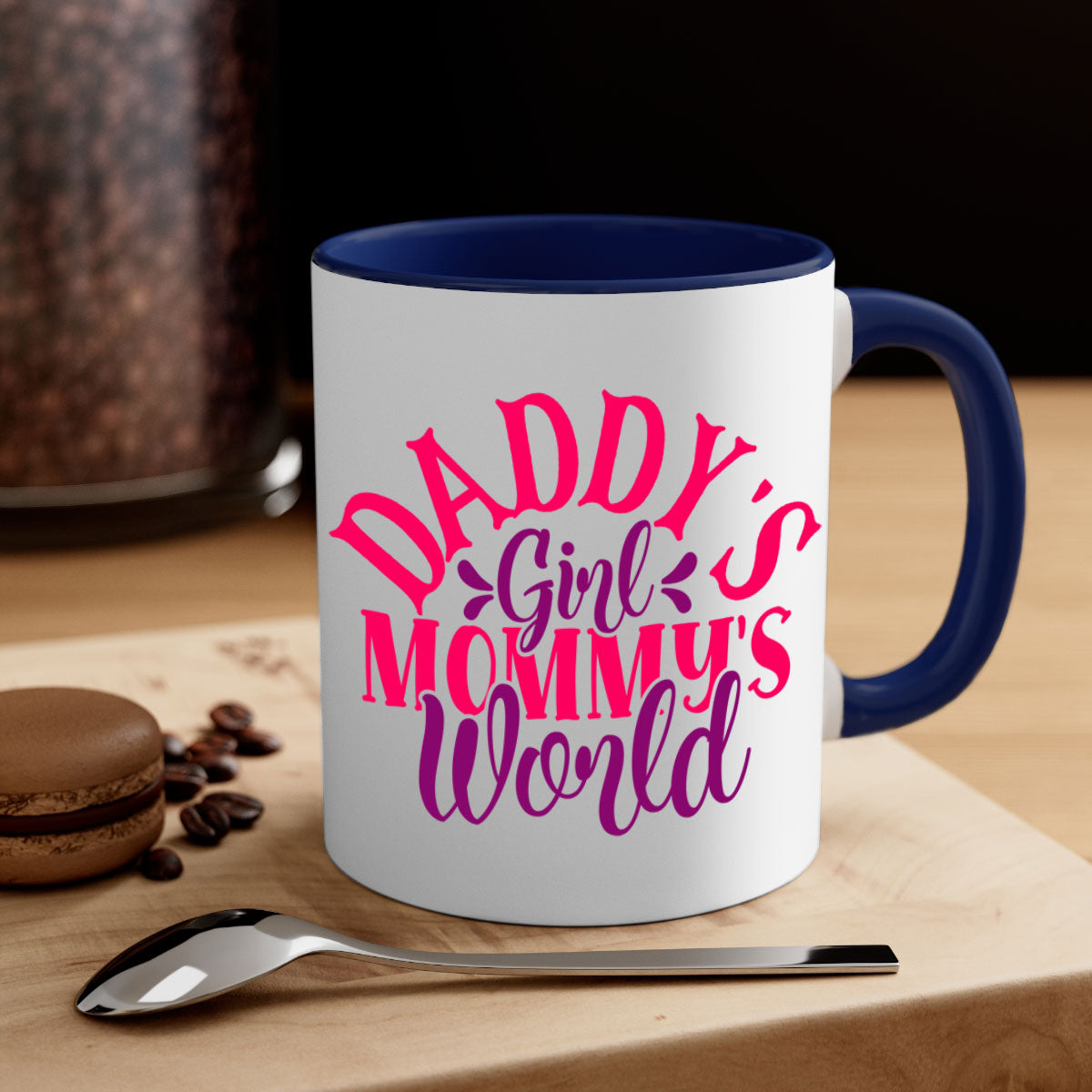 A two-tone ceramic coffee mug with a colored handle and interior, featuring the phrase 'Daddy's Girl Mommy's World' in a glossy finish.