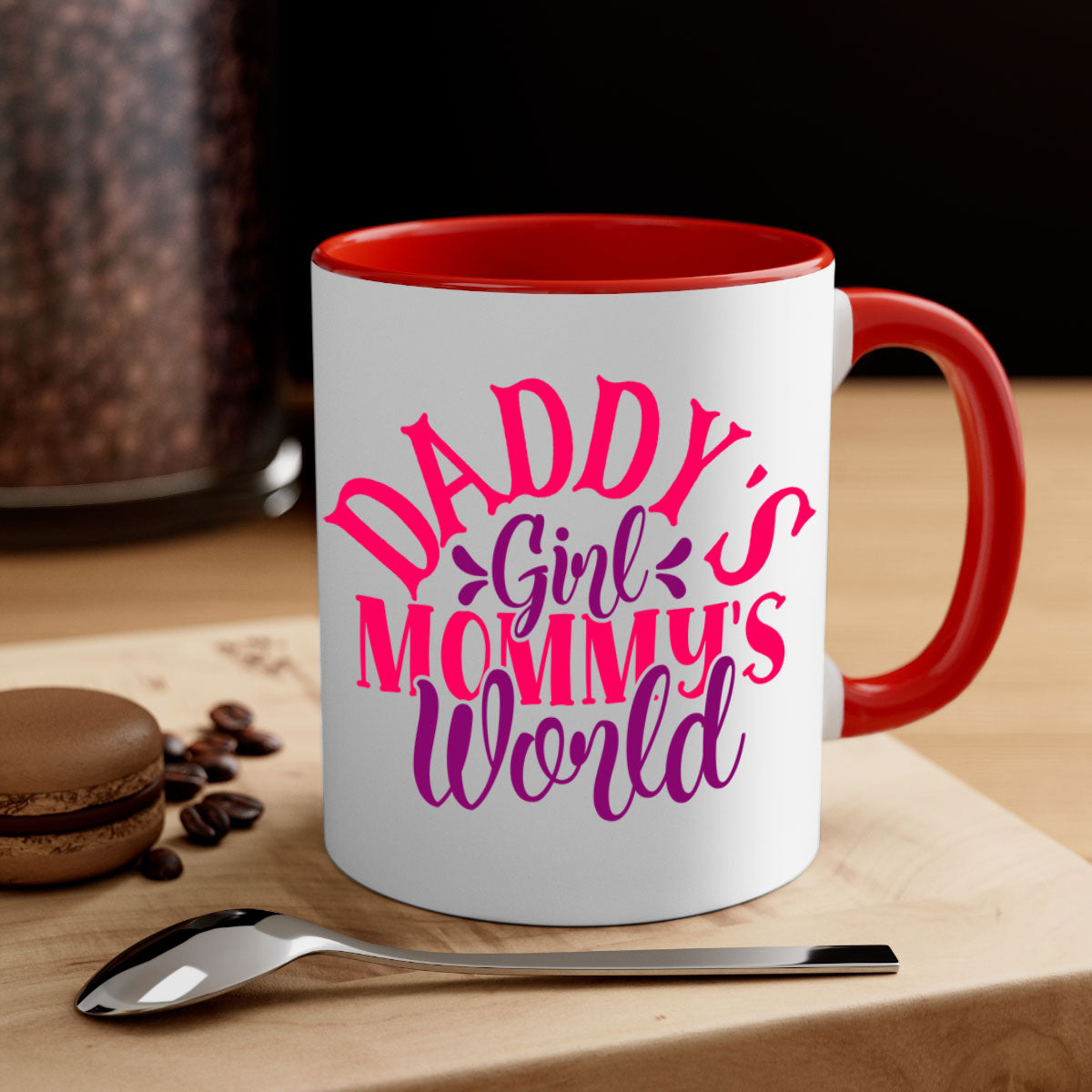 A two-tone ceramic coffee mug with a colored handle and interior, featuring the phrase 'Daddy's Girl Mommy's World' in a glossy finish.
