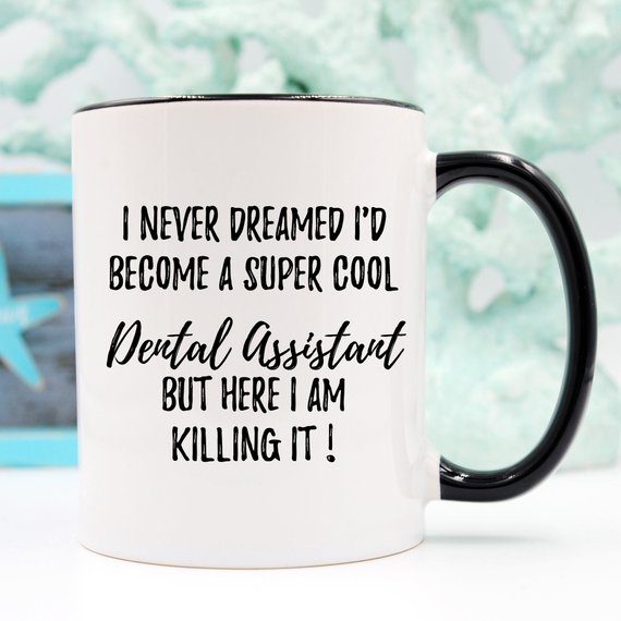 A white ceramic mug featuring a vibrant dental assistant design, showcasing both front and back prints.