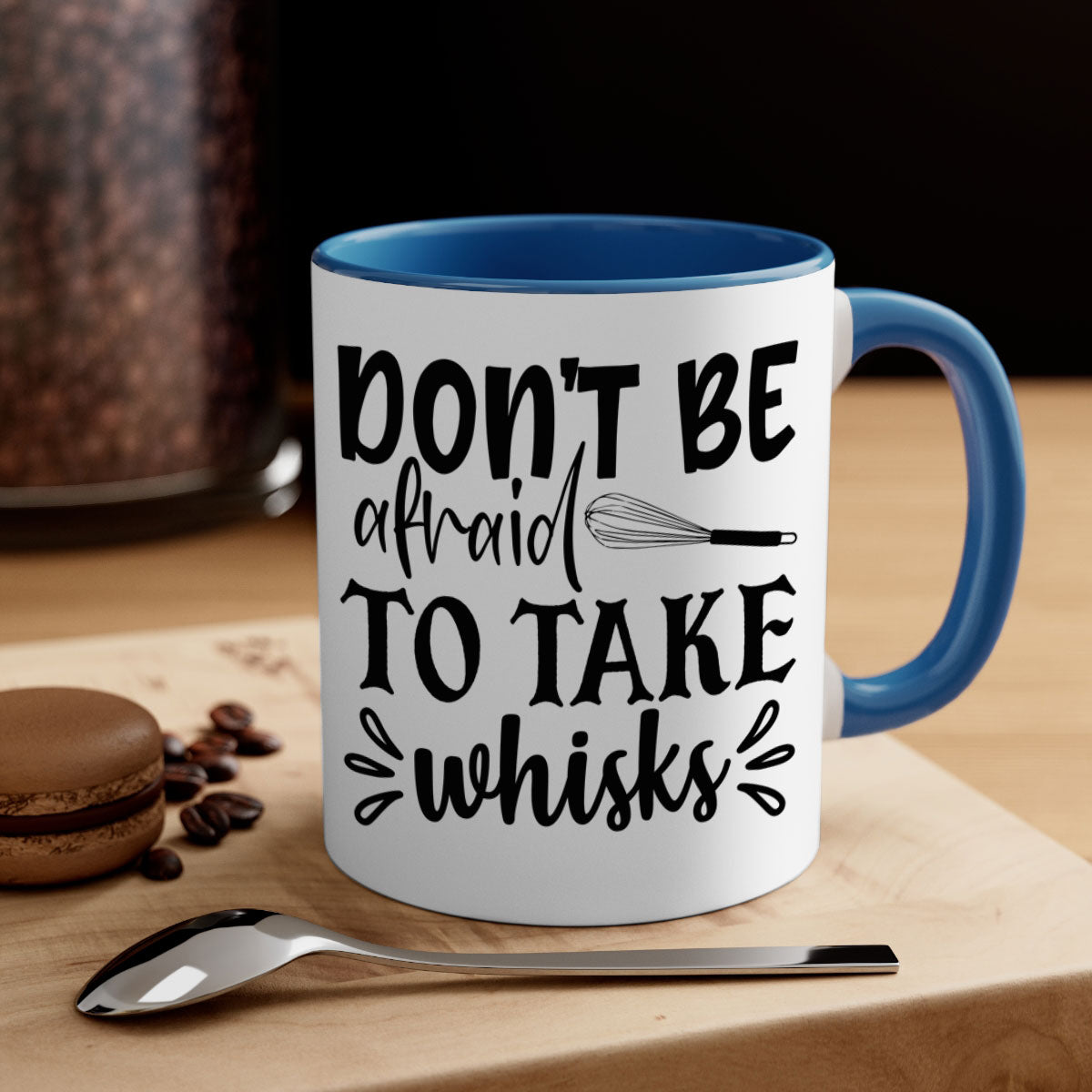 A stylish two-tone ceramic coffee mug with a colored handle and interior, featuring the phrase 'Don't Be Afraid to Take Whisks'.