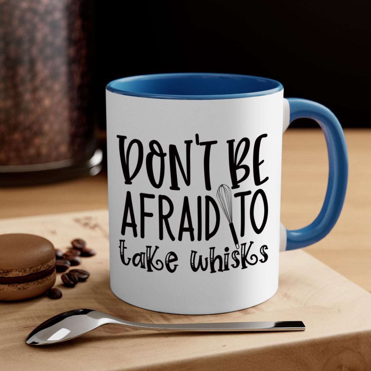 A stylish two-tone ceramic coffee mug with a colored handle and glossy finish, featuring the phrase 'Don't Be Afraid to Take Whisks'.