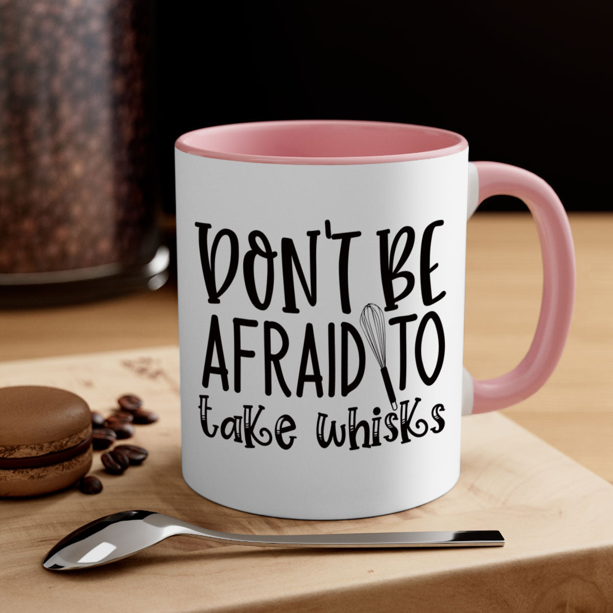 A stylish two-tone ceramic coffee mug with a colored handle and glossy finish, featuring the phrase 'Don't Be Afraid to Take Whisks'.