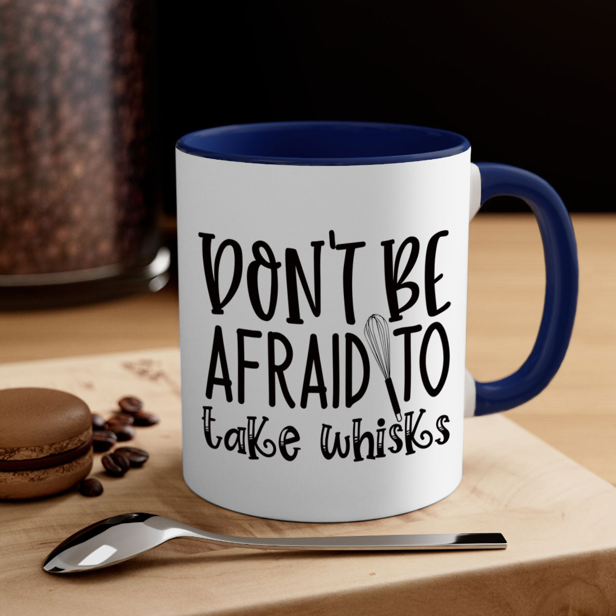 A stylish two-tone ceramic coffee mug with a colored handle and glossy finish, featuring the phrase 'Don't Be Afraid to Take Whisks'.