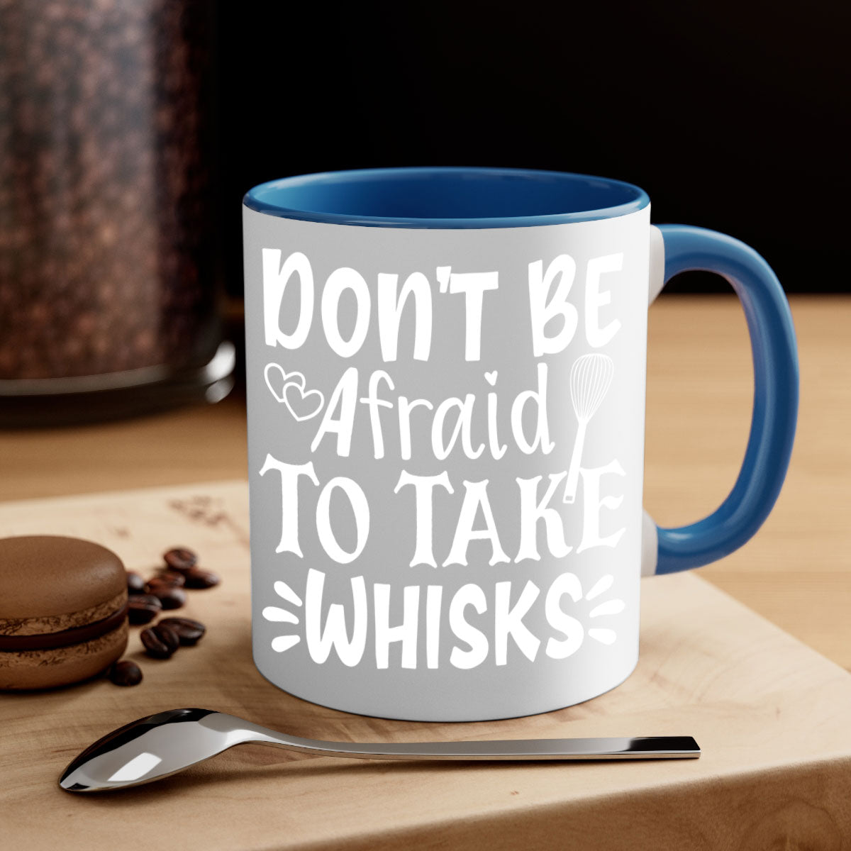 A stylish two-tone ceramic coffee mug with a colored handle and interior, featuring the phrase 'Don't Be Afraid to Take Whisks'.