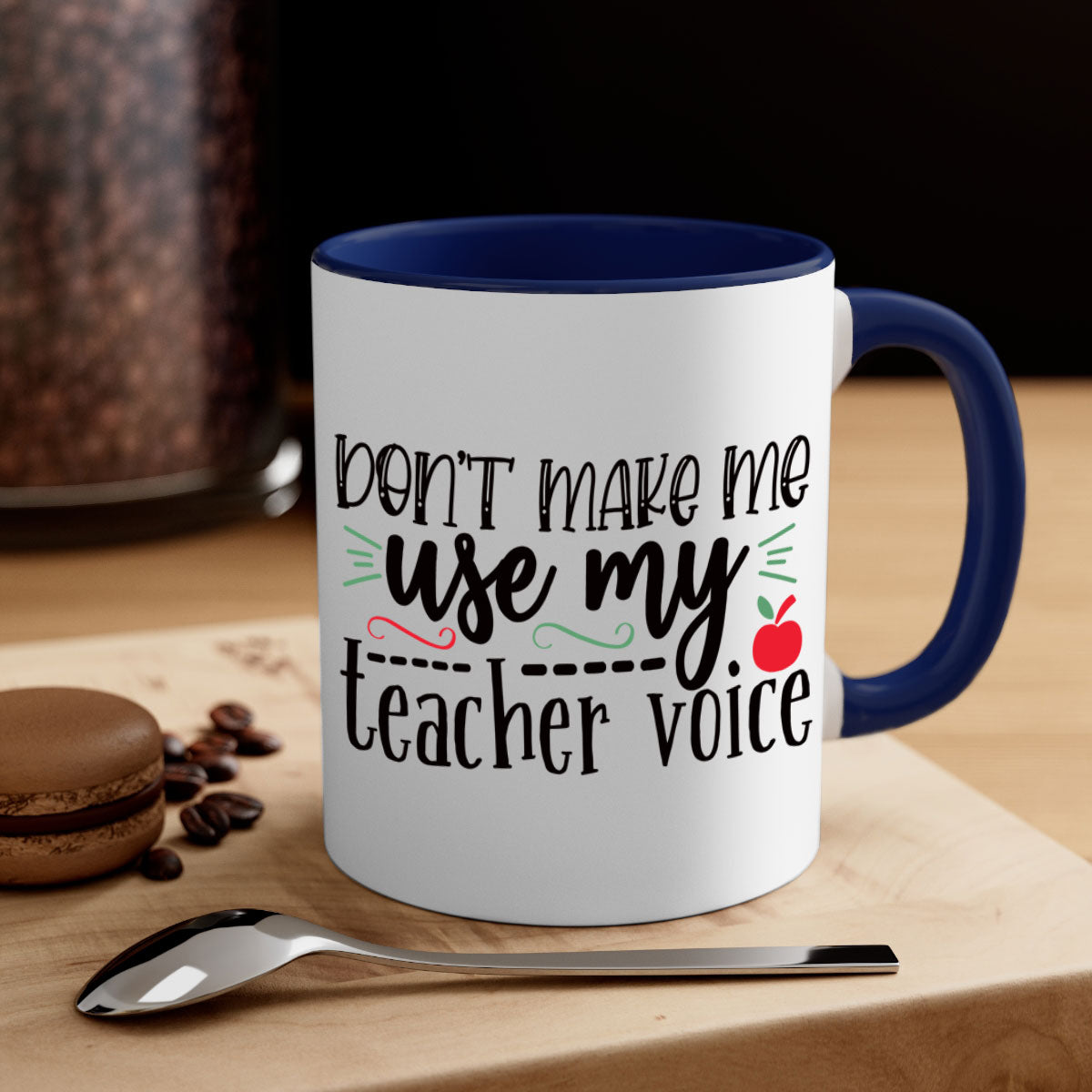 A stylish two-tone ceramic coffee mug with a colored handle and interior, featuring the phrase 'Don't Make Me Use My Teacher Voice' in a fun font.