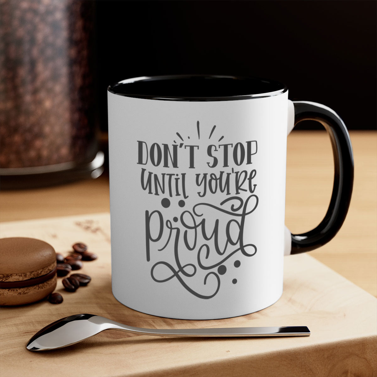 A stylish two-tone ceramic mug with a motivational quote 'Don't Stop Until You're Proud', featuring a colored handle and glossy finish.