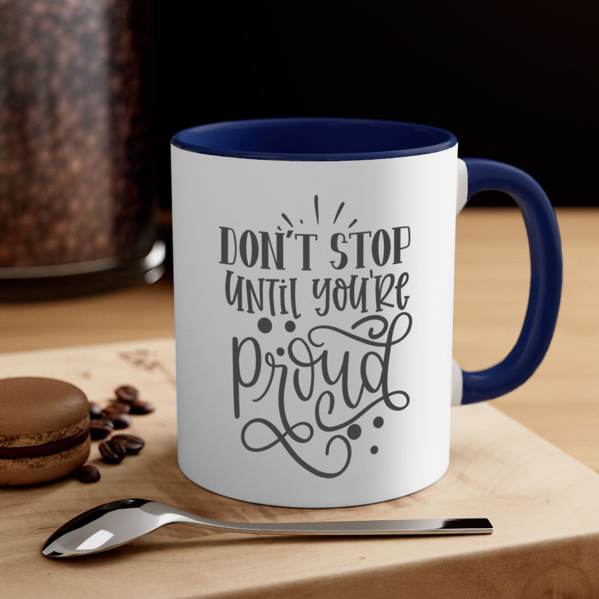 A stylish two-tone ceramic mug with a motivational quote 'Don't Stop Until You're Proud', featuring a colored handle and glossy finish.