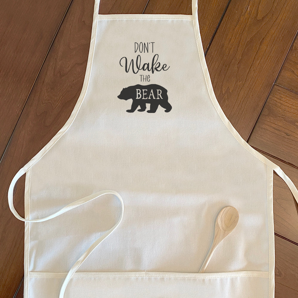 Don't Wake the Bear Women's Apron featuring elegant design, cotton canvas fabric, and divided front pocket.