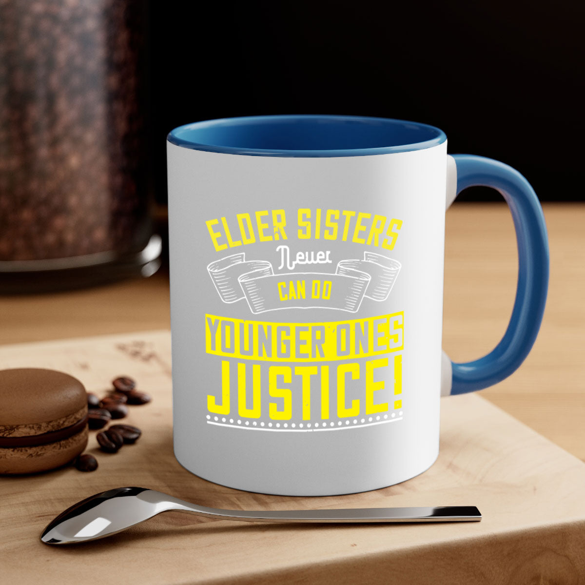 A stylish two-tone ceramic mug with a colored handle and interior, featuring the phrase 'elder sisters never can do younger ones justice' in a glossy finish.