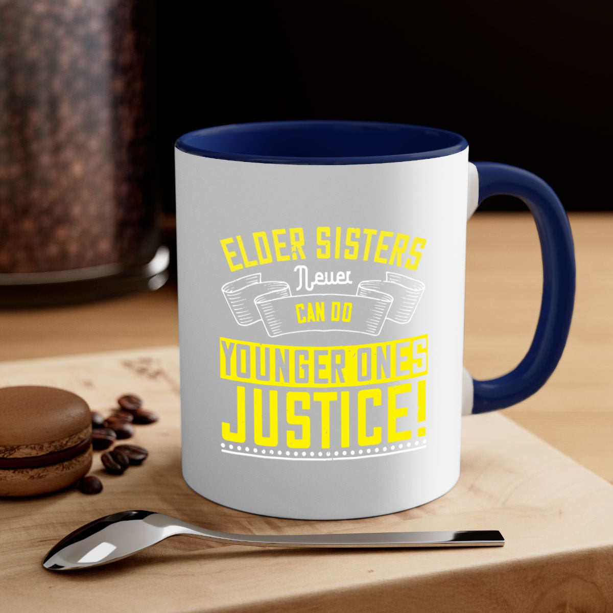 A stylish two-tone ceramic mug with a colored handle and interior, featuring the phrase 'elder sisters never can do younger ones justice' in a glossy finish.