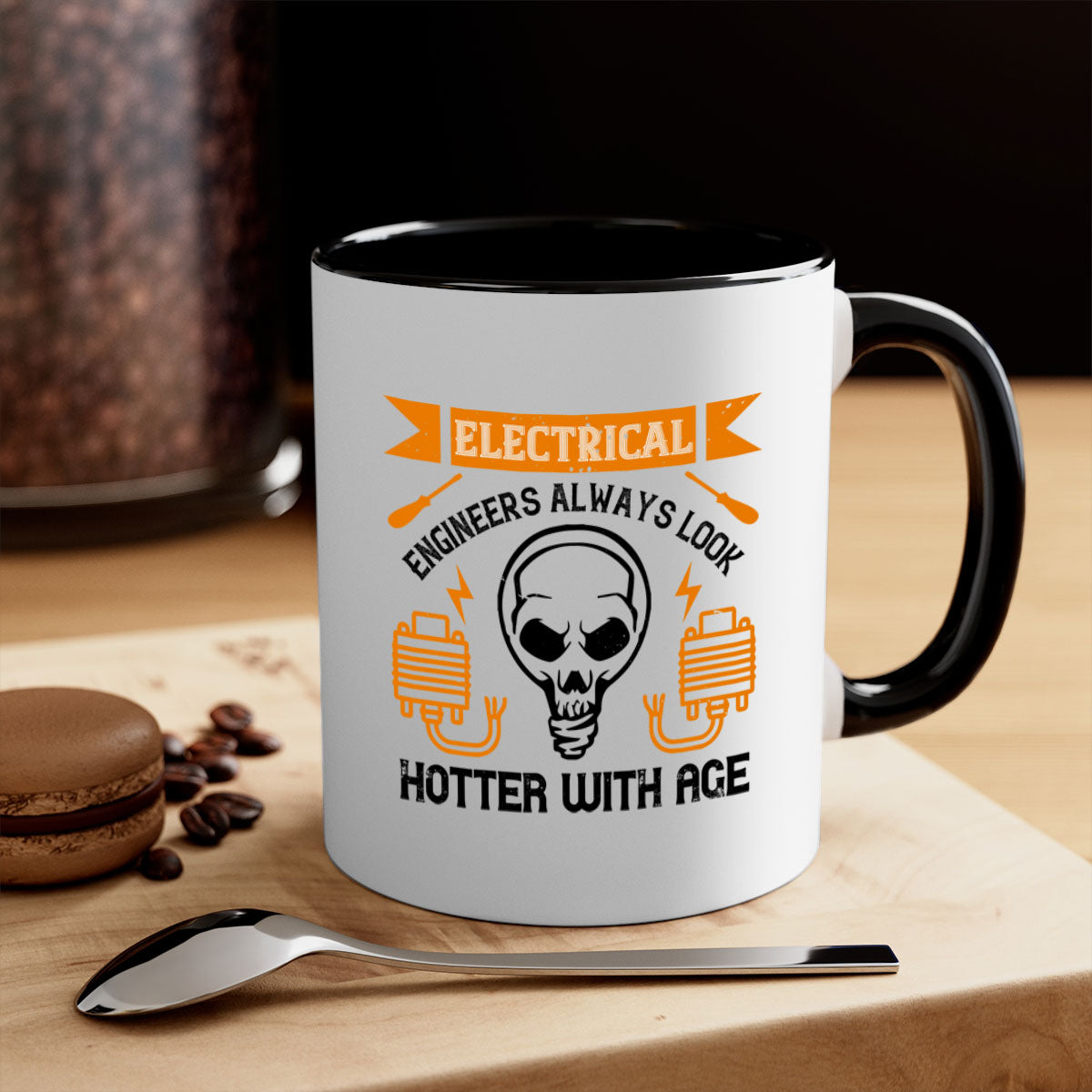 Two-tone ceramic mug with colored handle and interior, featuring the phrase 'Electrical engineers always look hotter with age' in a stylish font.