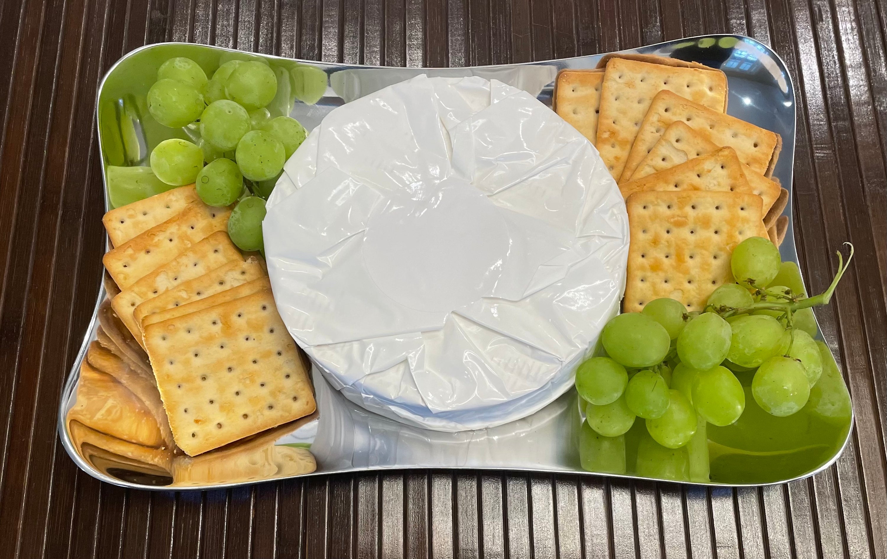 Elegant Serving Tray made of aluminum with a minimalist design, featuring round-shaped corners and a brushed finish.