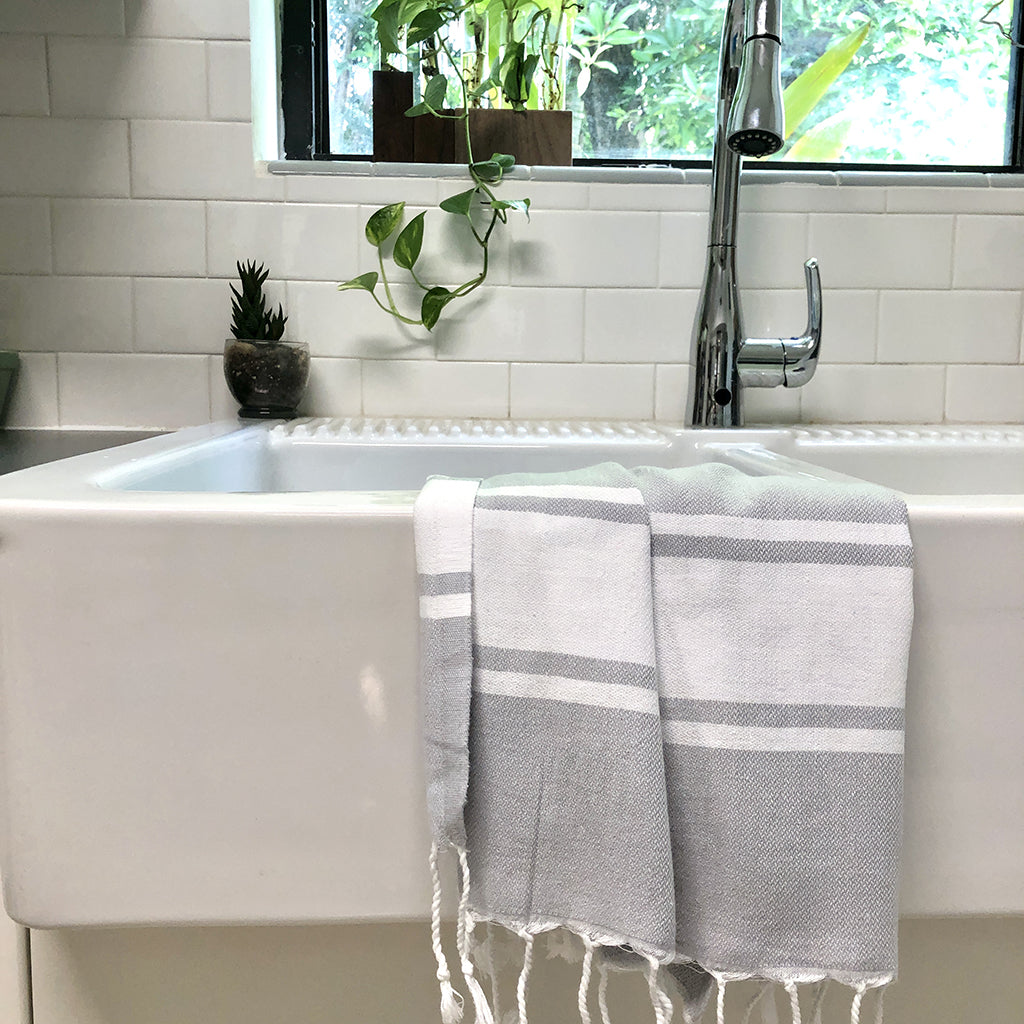 Essential Stripe Turkish Hand Towel with hand-knotted fringe edges, showcasing its vibrant stripe pattern and high-quality Turkish cotton.
