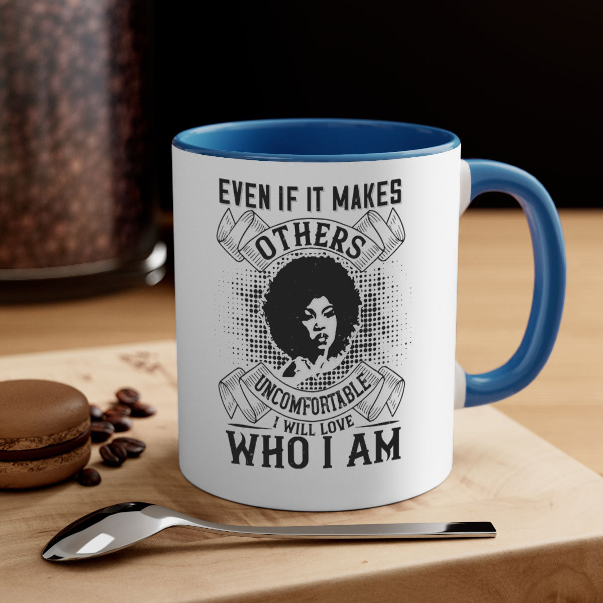 A two-tone ceramic mug with a colored handle and interior, featuring the phrase 'Even if it makes others uncomfortable I will love who I am' in a stylish font.