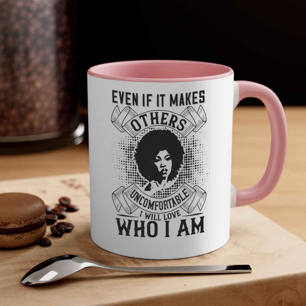 A two-tone ceramic mug with a colored handle and interior, featuring the phrase 'Even if it makes others uncomfortable I will love who I am' in a stylish font.