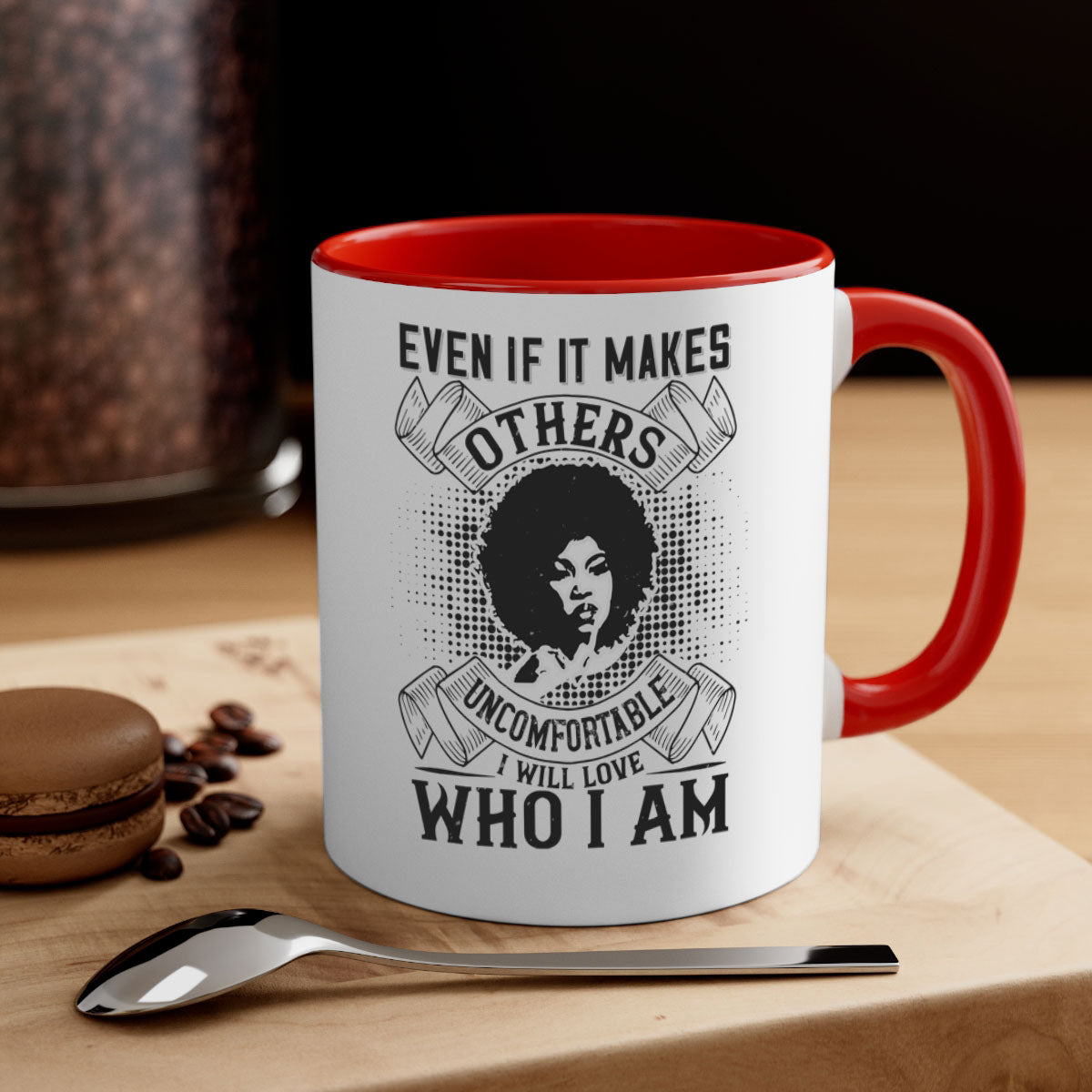 A two-tone ceramic mug with a colored handle and interior, featuring the phrase 'Even if it makes others uncomfortable I will love who I am' in a stylish font.