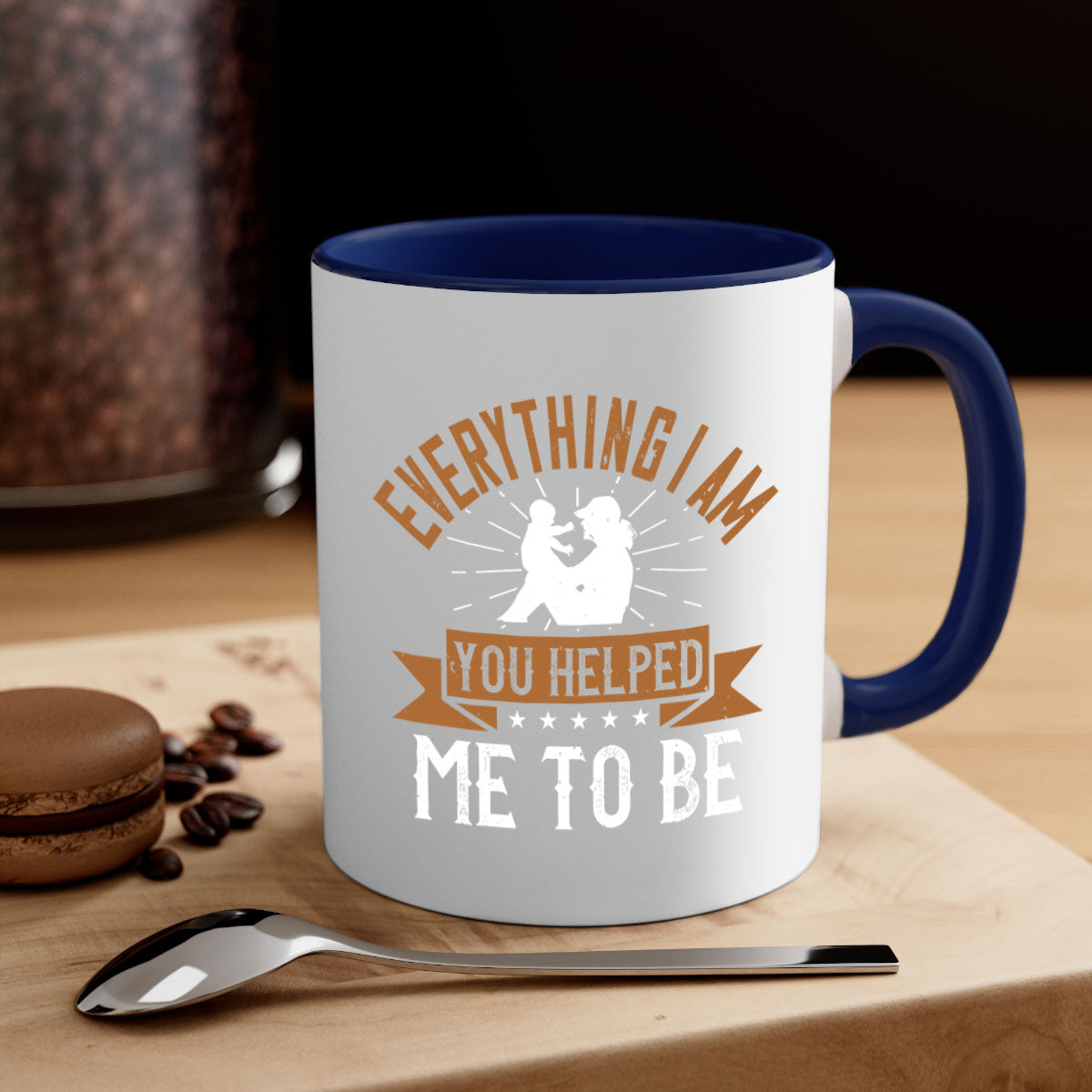 A two-tone ceramic coffee mug with a glossy finish, featuring a colored handle and interior, designed with the phrase 'Everything I Am You Helped Me to Be 188#' for moms.
