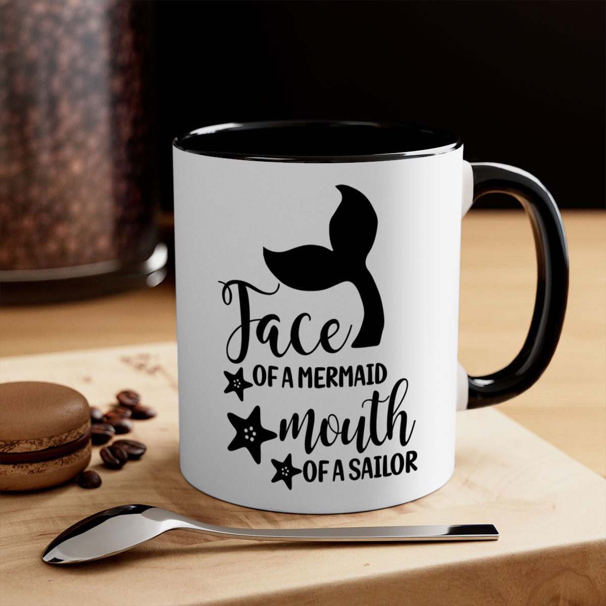 A whimsical ceramic coffee mug featuring a mermaid face design, with a glossy finish and a colored handle, available in multiple colors.