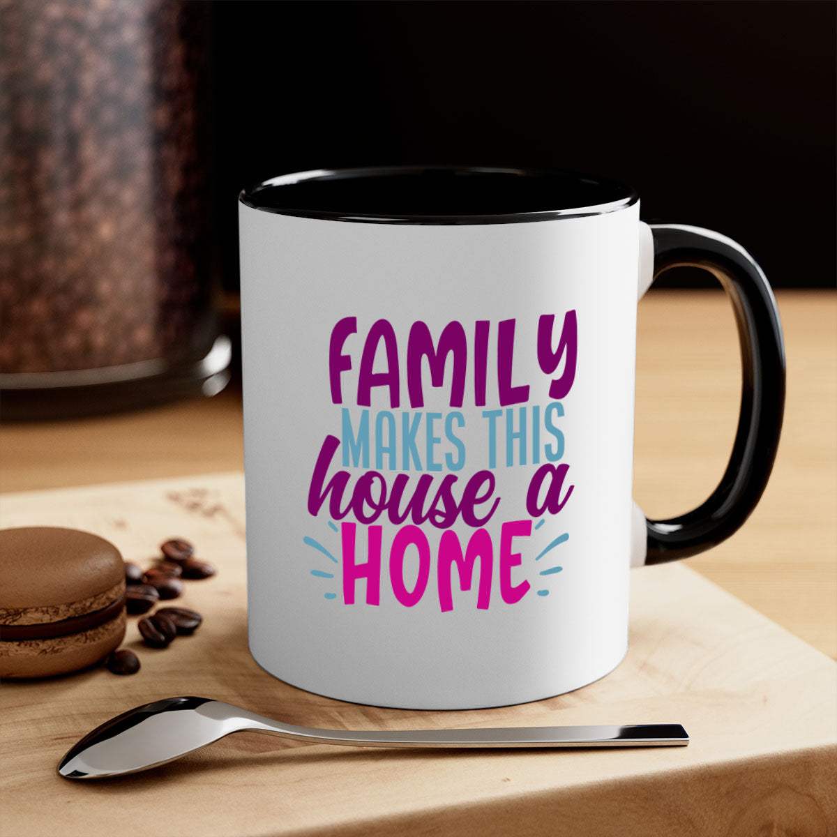 A two-tone ceramic coffee mug with the phrase 'Family Makes This House a Home' printed on it, featuring a colored handle and glossy finish.