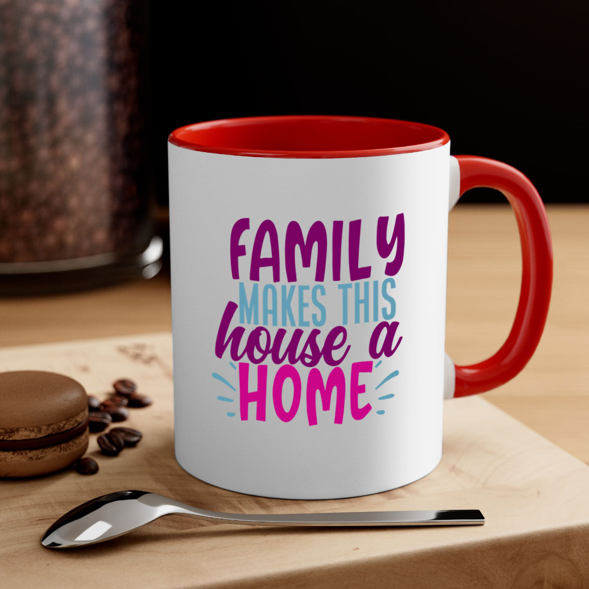 A two-tone ceramic coffee mug with the phrase 'Family Makes This House a Home' printed on it, featuring a colored handle and glossy finish.