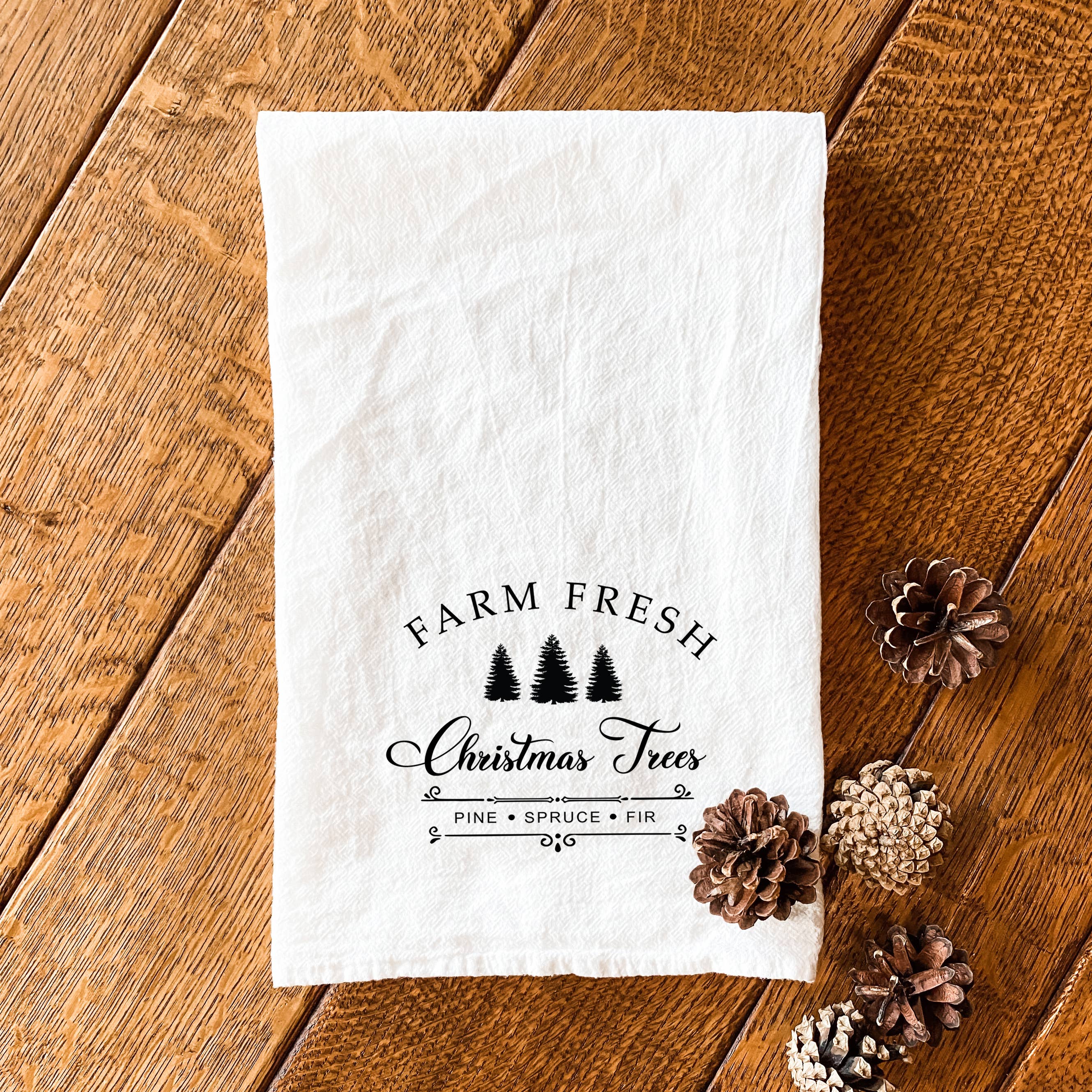 Farm Fresh Christmas Trees cotton tea towel featuring a vibrant holiday design, made from 100% absorbent cotton.