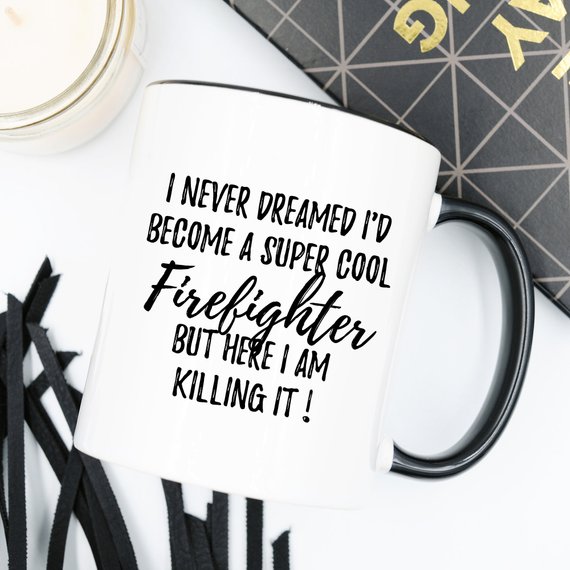 A white ceramic mug featuring a vibrant firefighter design printed on both sides, perfect for coffee or tea.