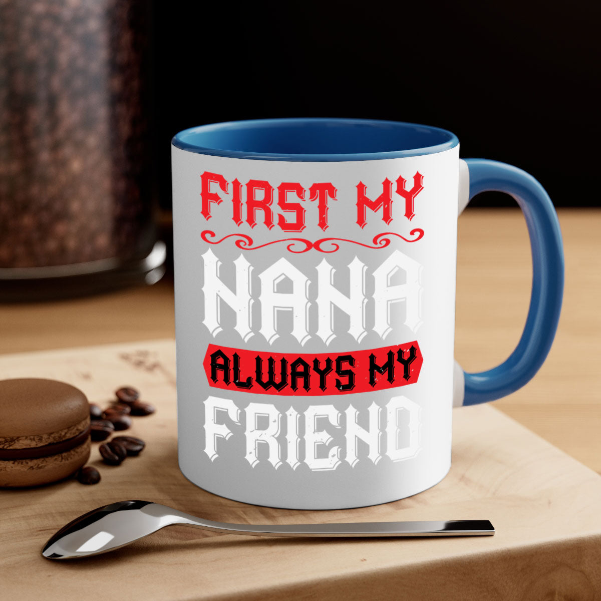 Ceramic coffee mug with a glossy finish, featuring a colored handle and interior, displaying the text 'FIRST MY NANA ALWAYS MY FRIEND'.