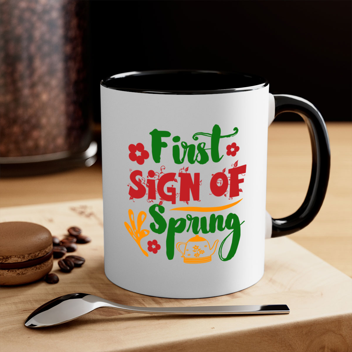 A two-tone ceramic coffee mug with a colored handle and interior, showcasing the First Sign of Spring design.