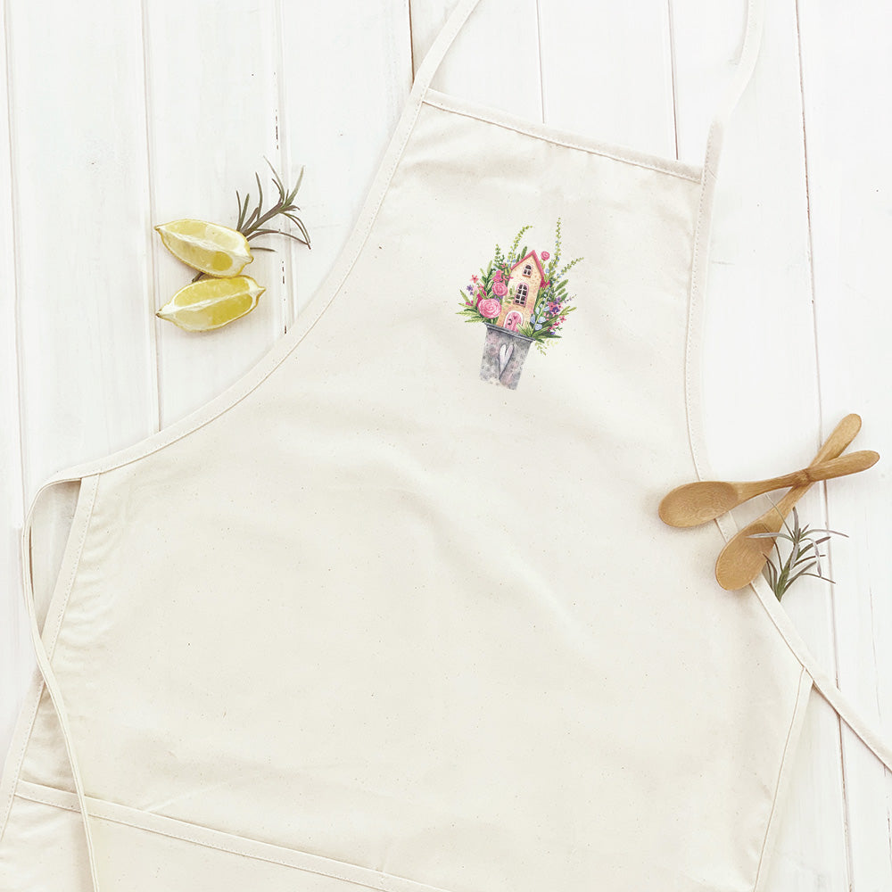 Floral Pail Fairy House Women's Apron featuring a vibrant floral design, adjustable neck strap, and divided front pocket.