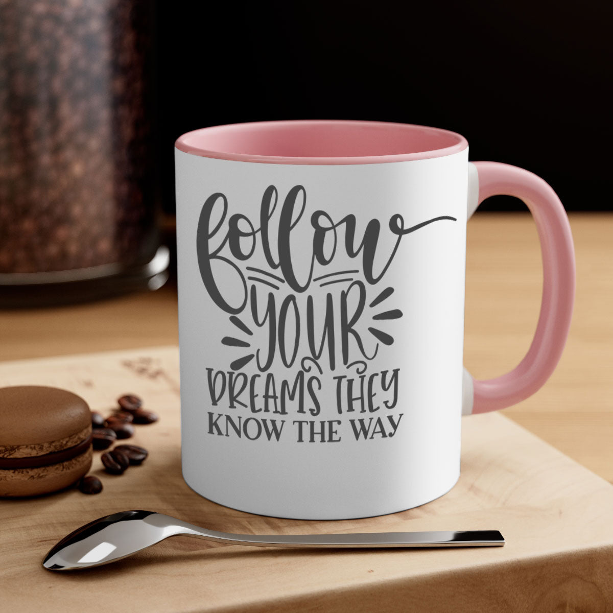 A two-tone ceramic mug with the motivational phrase 'Follow Your Dreams They Know the Way', featuring a glossy finish and a colored handle.