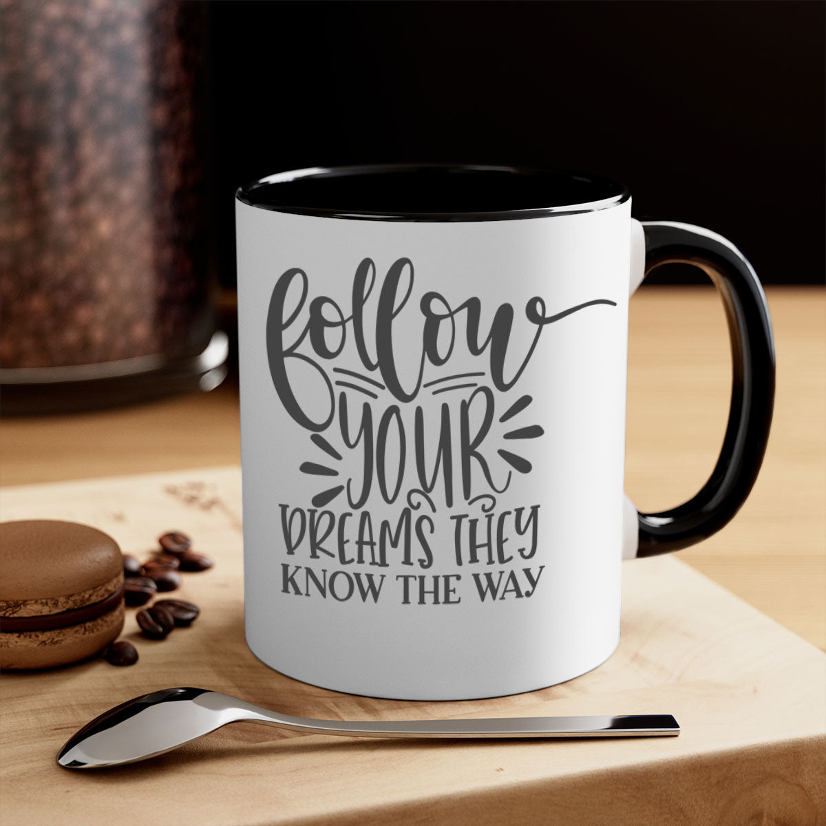 A two-tone ceramic mug with the motivational phrase 'Follow Your Dreams They Know the Way', featuring a glossy finish and a colored handle.