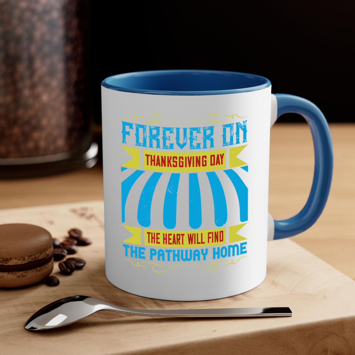 A two-tone ceramic mug with a colored handle and interior, featuring the phrase 'Forever on Thanksgiving Day the Heart Will Find the Pathway Home'.