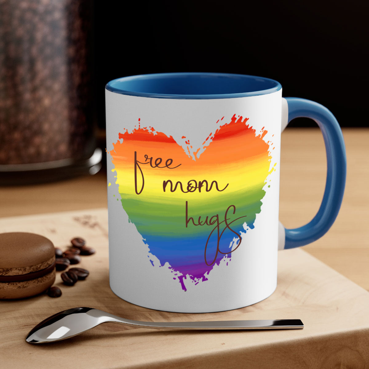 Free Mom Hugs Rainbow Pride Mug with colorful handle and glossy finish, showcasing vibrant rainbow design for LGBT pride.