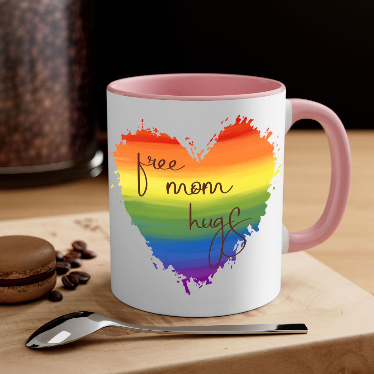 Free Mom Hugs Rainbow Pride Mug with colorful handle and glossy finish, showcasing vibrant rainbow design for LGBT pride.