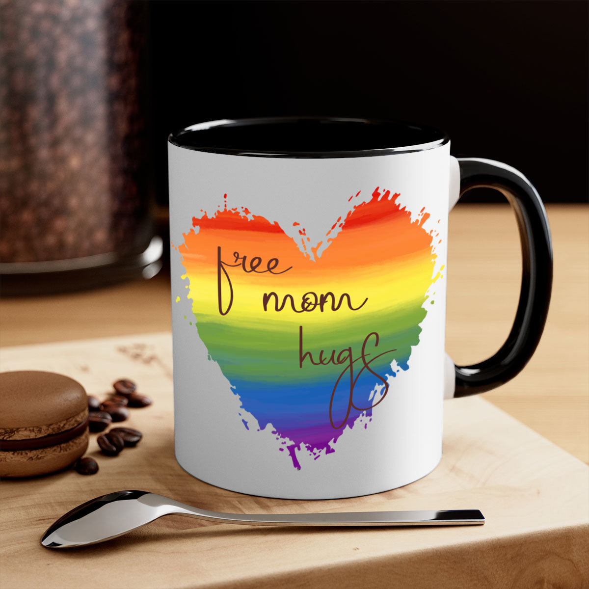 Free Mom Hugs Rainbow Pride Mug with colorful handle and glossy finish, showcasing vibrant rainbow design for LGBT pride.