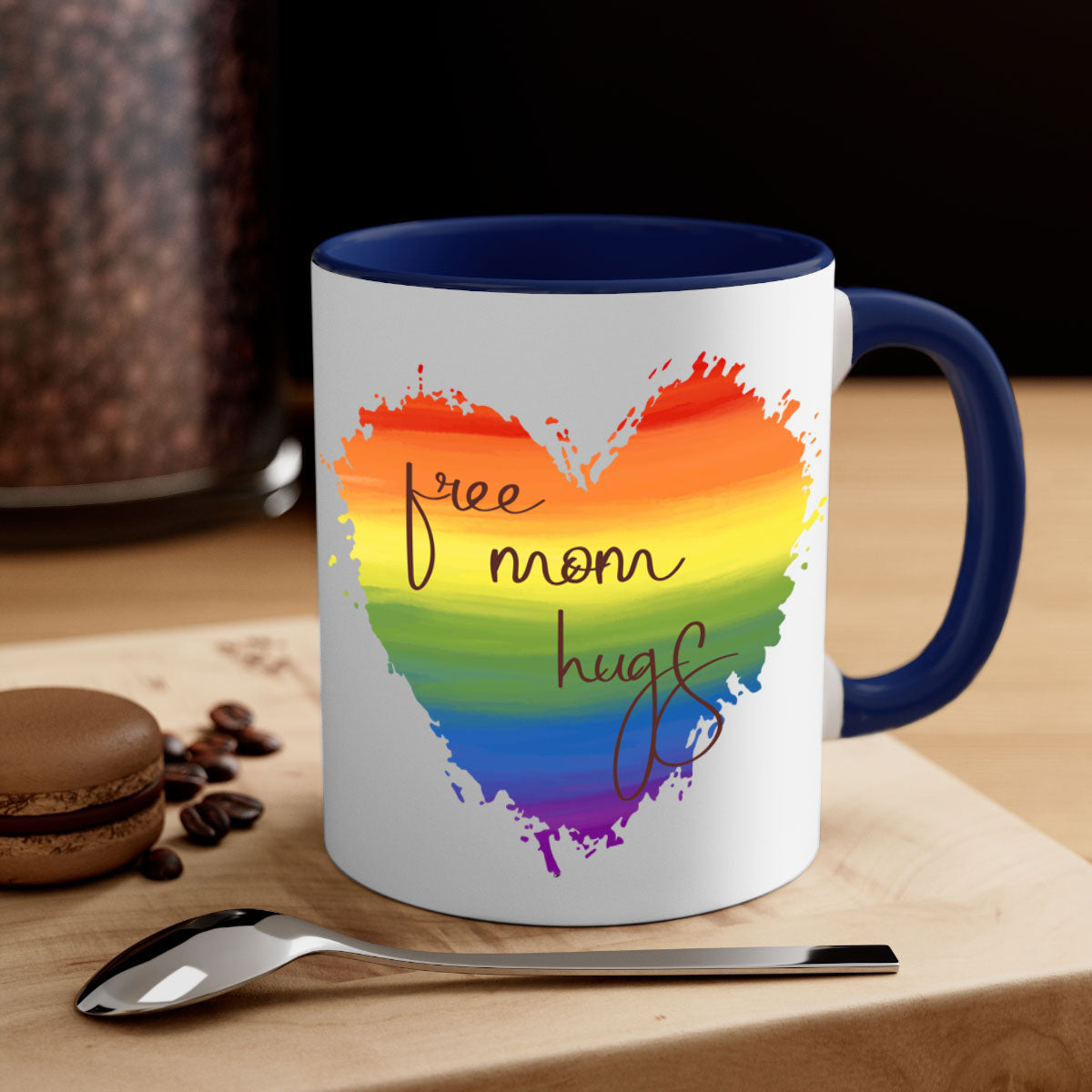 Free Mom Hugs Rainbow Pride Mug with colorful handle and glossy finish, showcasing vibrant rainbow design for LGBT pride.
