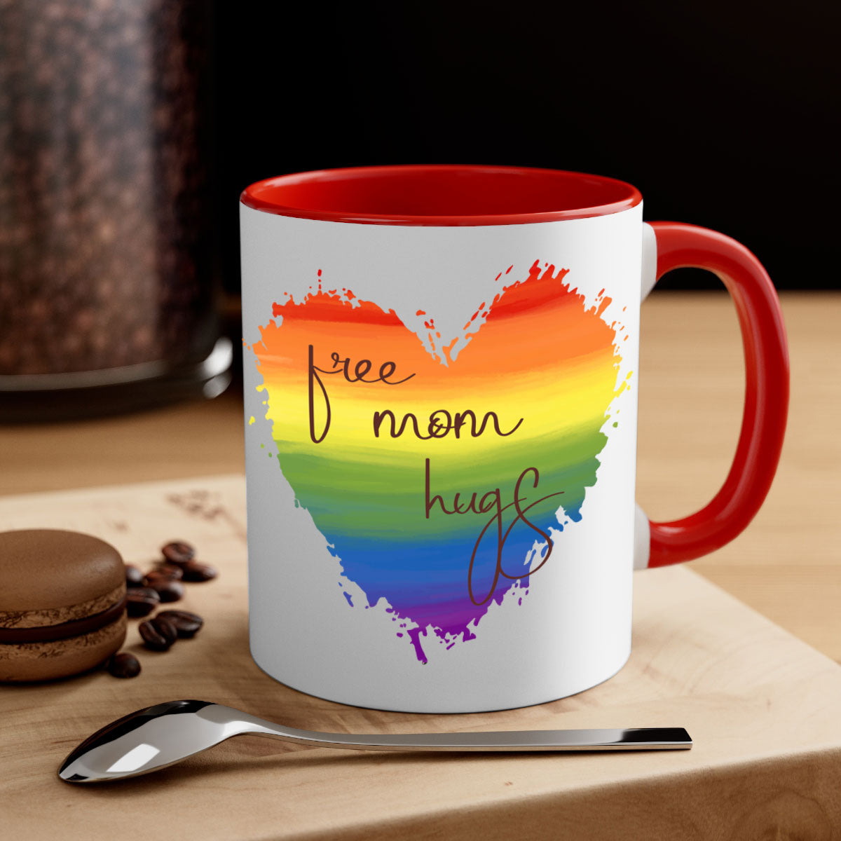 Free Mom Hugs Rainbow Pride Mug with colorful handle and glossy finish, showcasing vibrant rainbow design for LGBT pride.