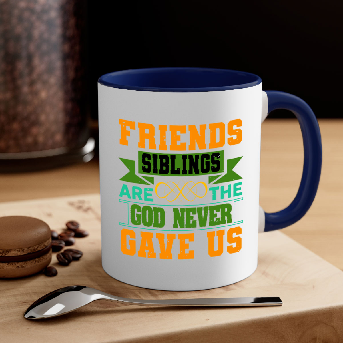 Ceramic mug with a two-tone design featuring a colored handle and interior, displaying the phrase 'Friends are the siblings God never gave us'.