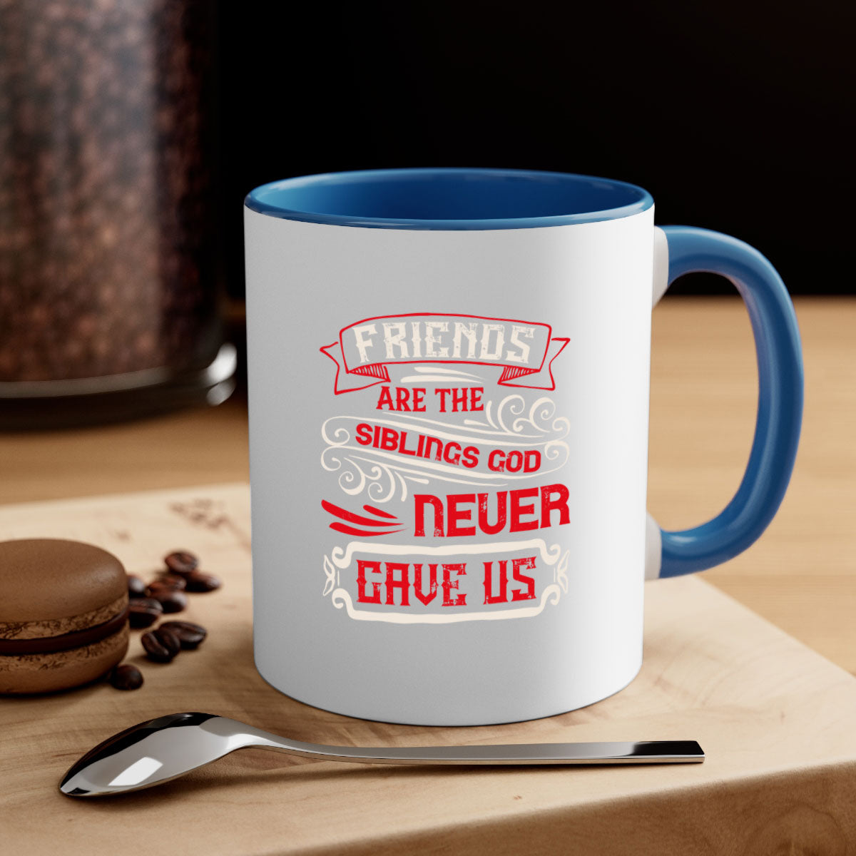 Two-tone ceramic mug with colored handle and interior, featuring the phrase 'Friends are the siblings God never gave us' in a glossy finish.