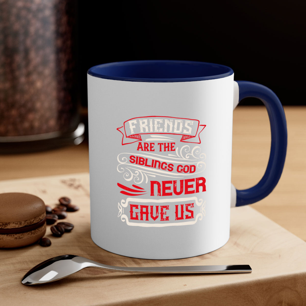 Two-tone ceramic mug with colored handle and interior, featuring the phrase 'Friends are the siblings God never gave us' in a glossy finish.