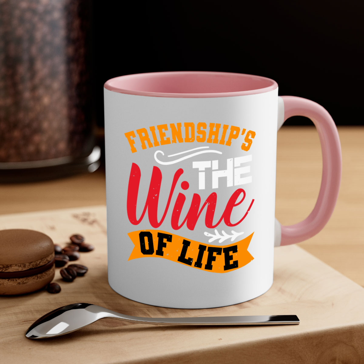Two-tone ceramic mug with colored handle and glossy finish, featuring the phrase 'Friendship’s the wine of life'.
