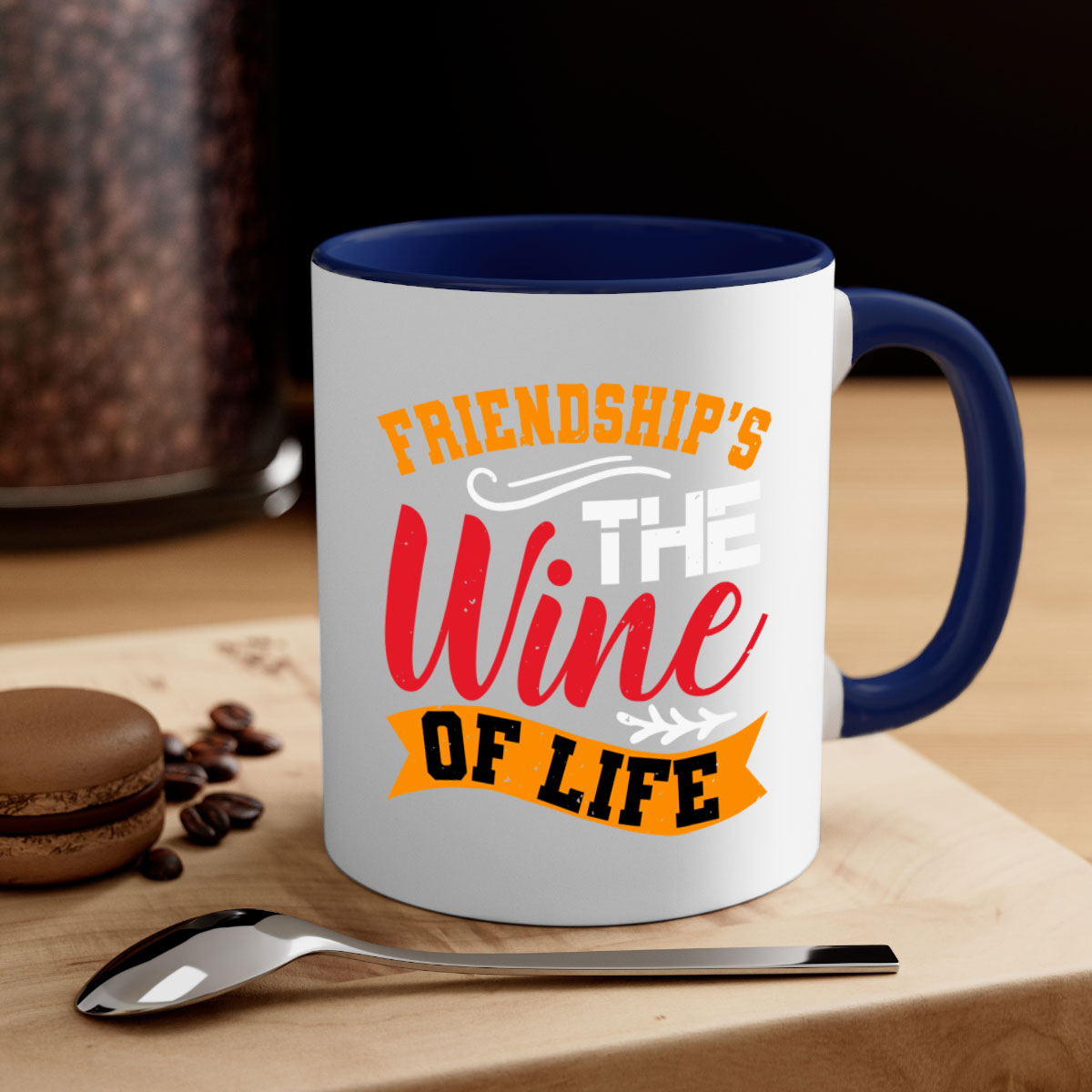 Two-tone ceramic mug with colored handle and glossy finish, featuring the phrase 'Friendship’s the wine of life'.
