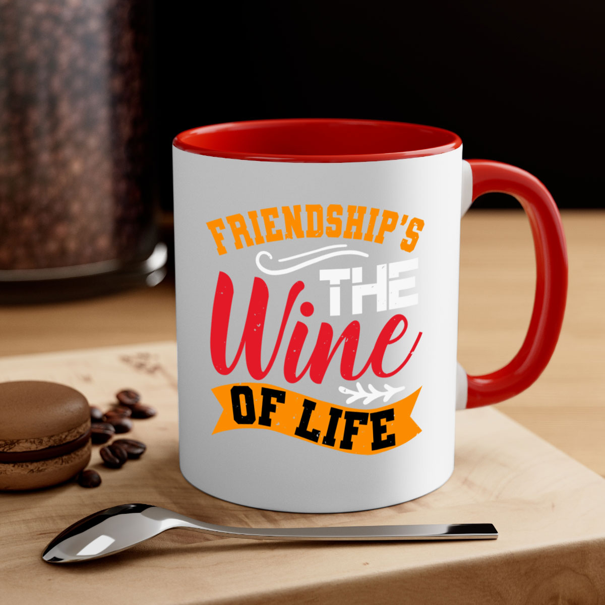 Two-tone ceramic mug with colored handle and glossy finish, featuring the phrase 'Friendship’s the wine of life'.