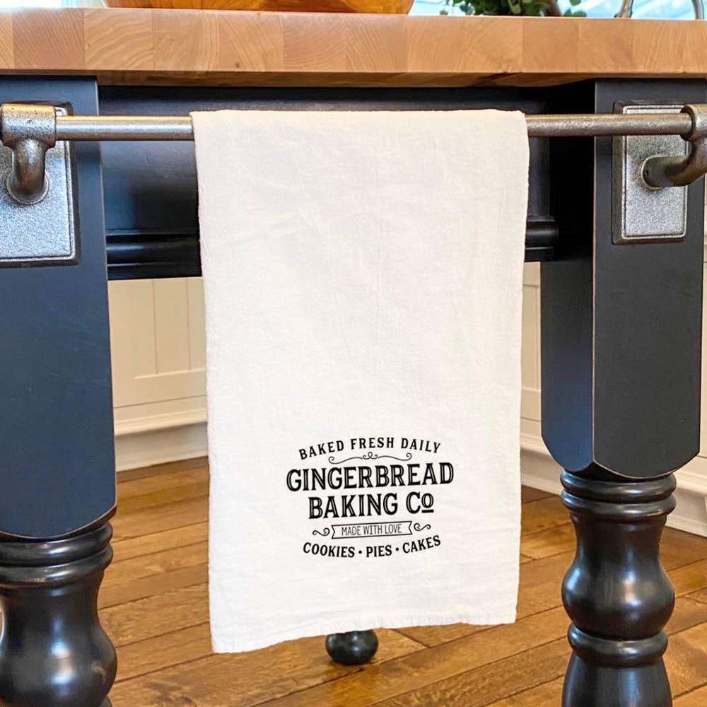 Gingerbread Baking Co. Cotton Tea Towel featuring vibrant designs and hemmed edges, perfect for kitchen use.