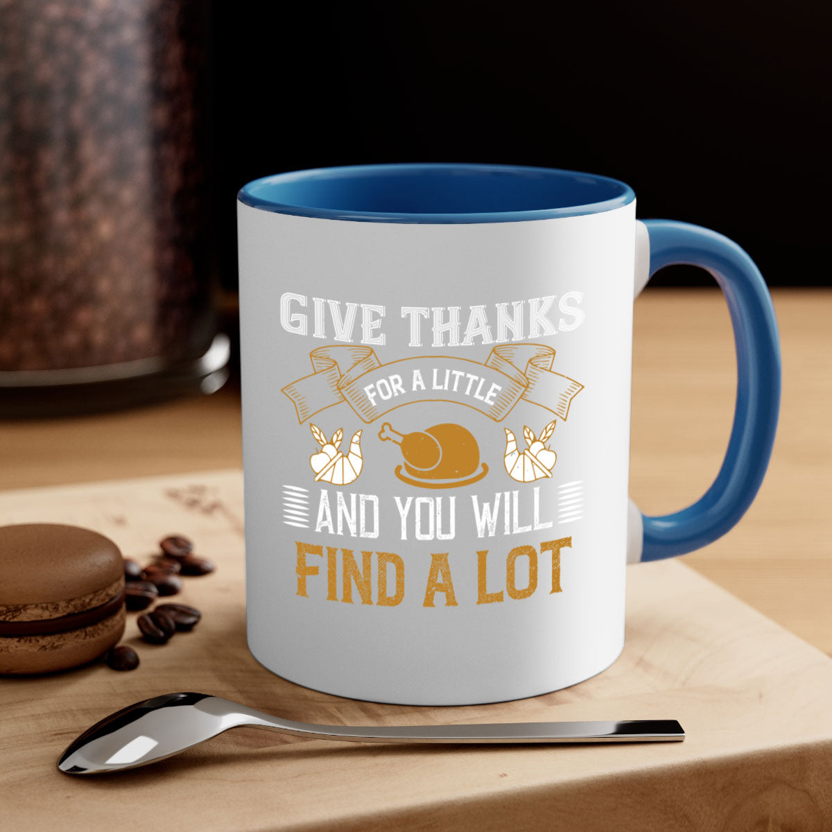 Two-tone ceramic mug with 'Give Thanks for a Little and You Will Find a Lot' design, featuring a colored handle and glossy finish.