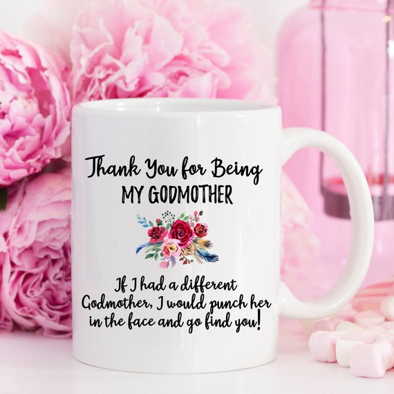 A beautiful white ceramic mug designed for godmothers, featuring a heartfelt message printed on both sides.