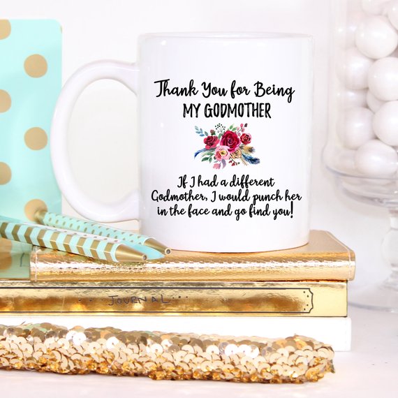 A beautiful white ceramic mug designed for godmothers, featuring a heartfelt message printed on both sides.